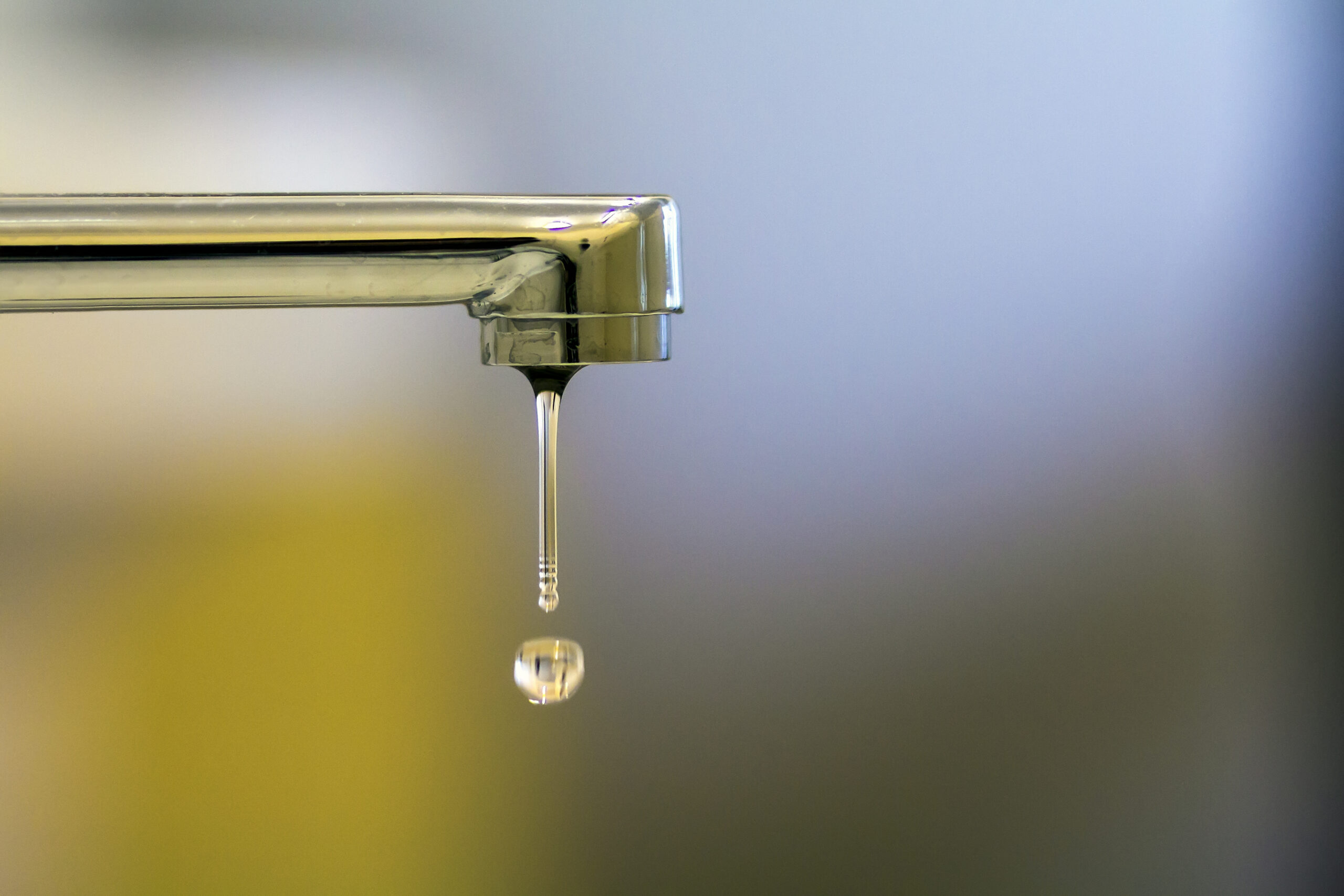 Bathroom faucet slowly dripping water.