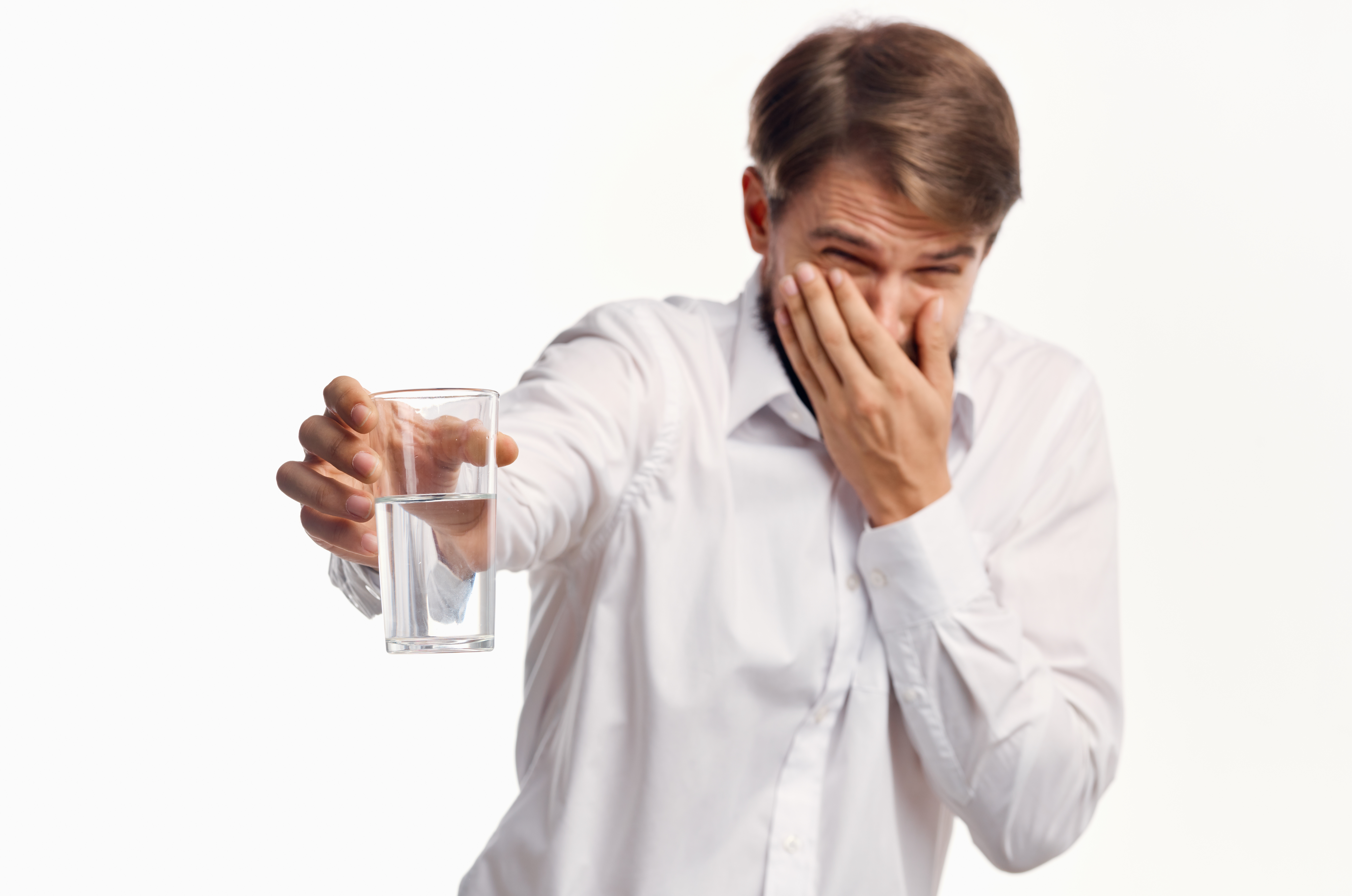 Man turning up his nose at bad smelling water.